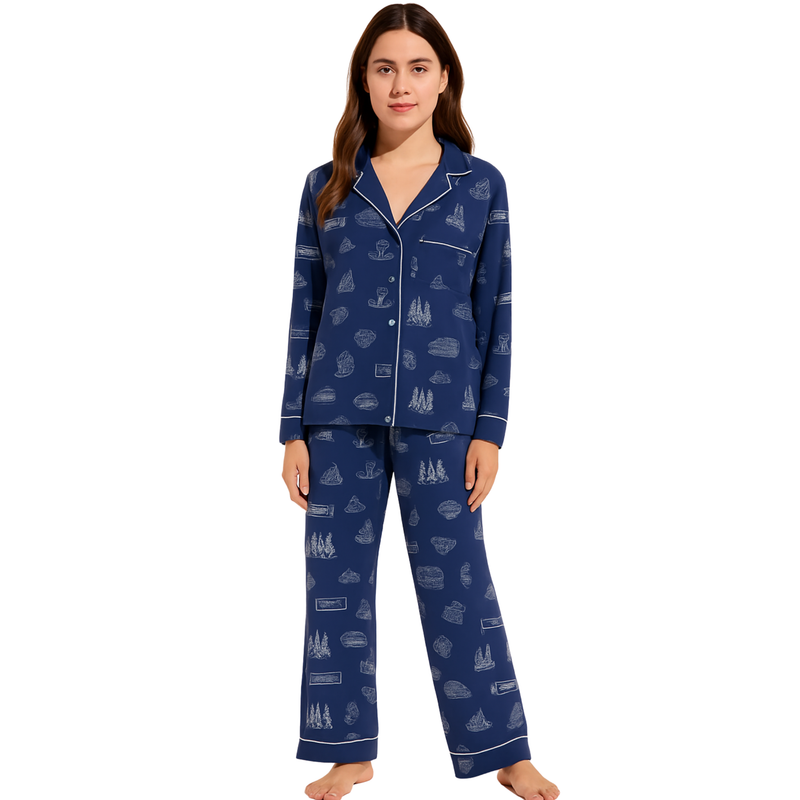 Woman wearing a navy blue pajama set with white patterns on a white background