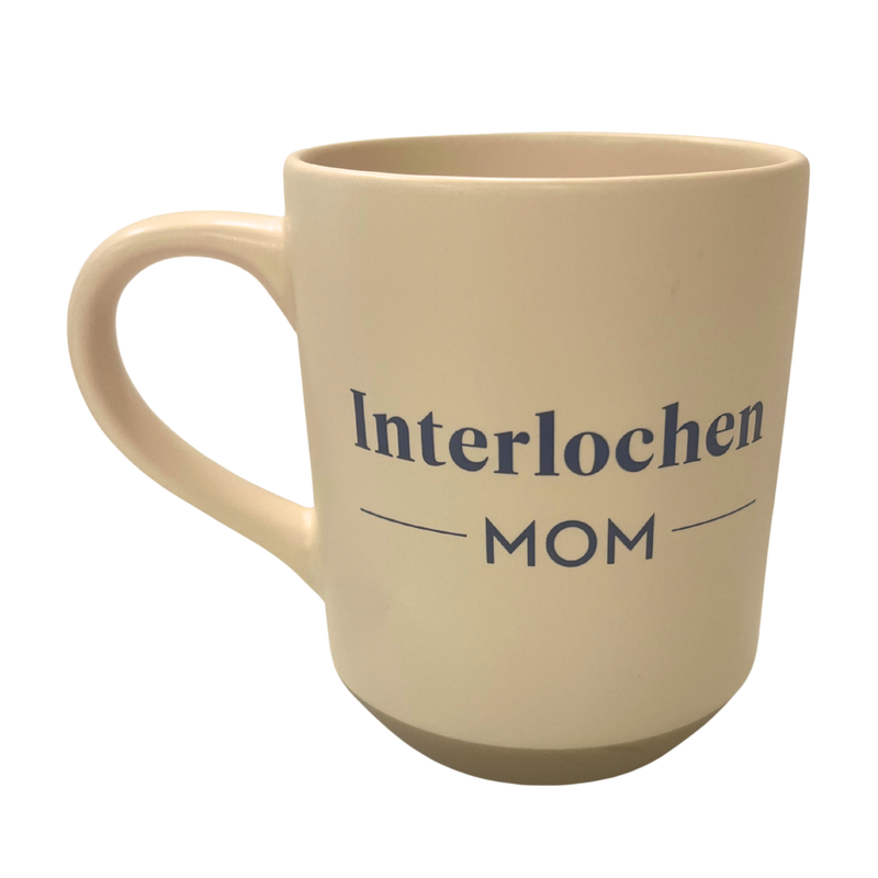 Beige mug with 'Interlochen Mom' text on a white background