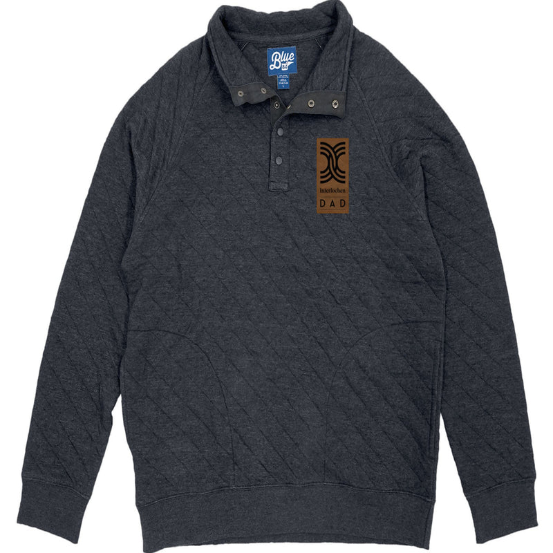 A navy quilted 1/4 snap up pullover with a visible brand tag on the upper left side.